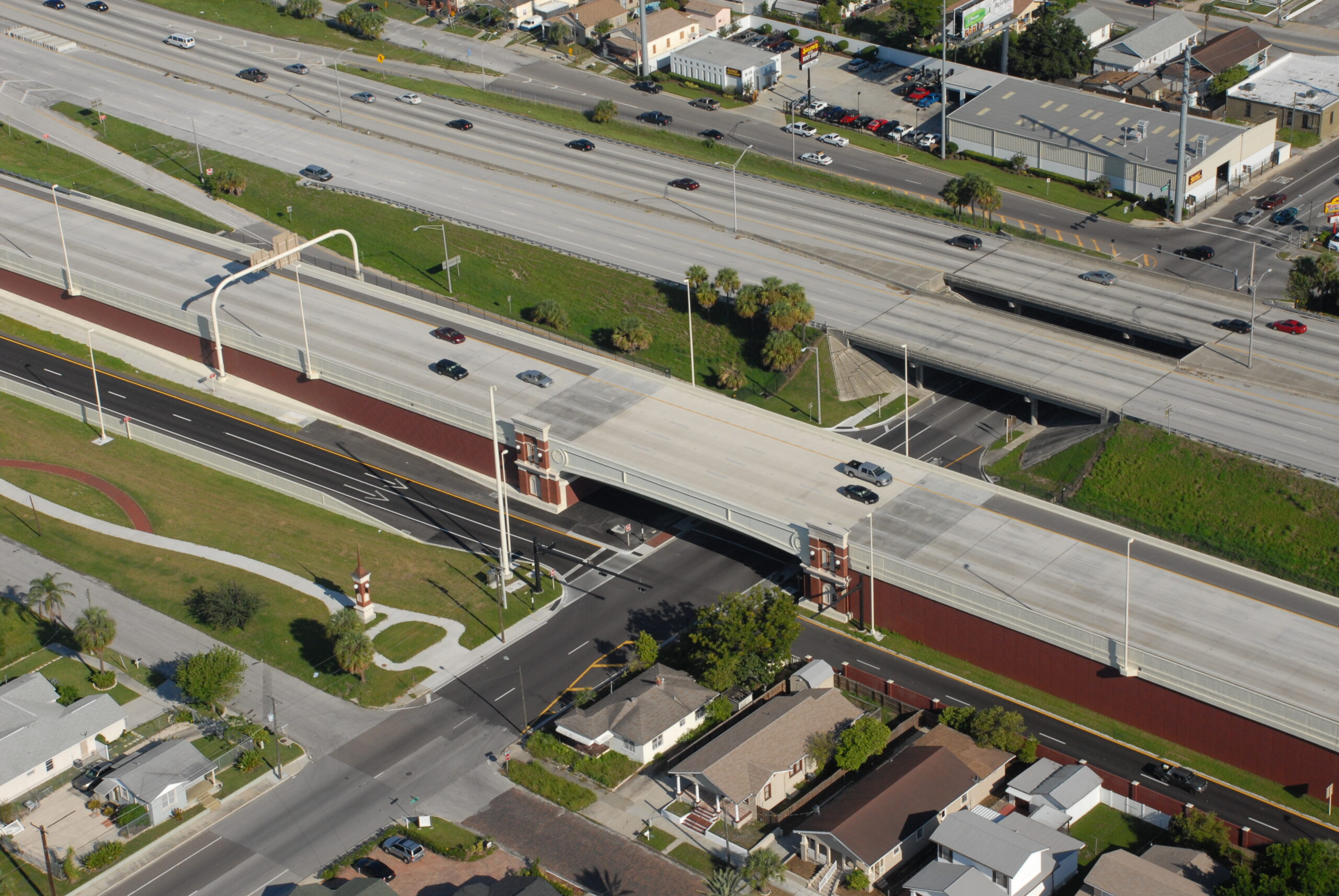 Aerial view of I-275 overpass near residential area and businesses, with light traffic