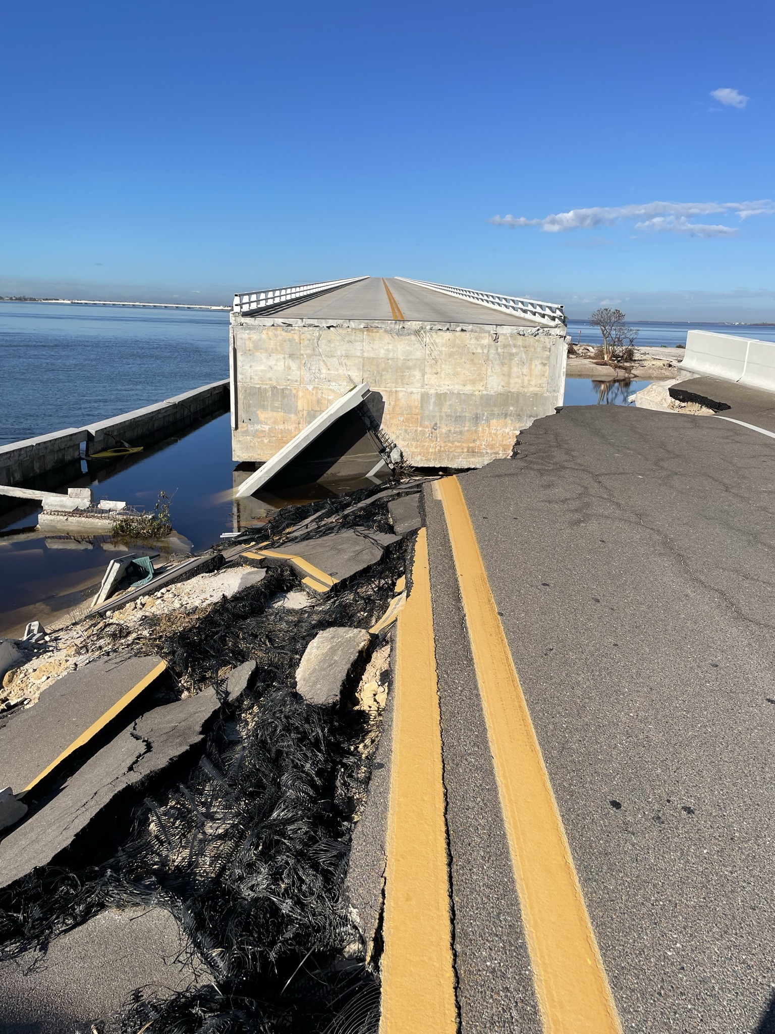 Collapsed bridge with broken road and exposed rebar