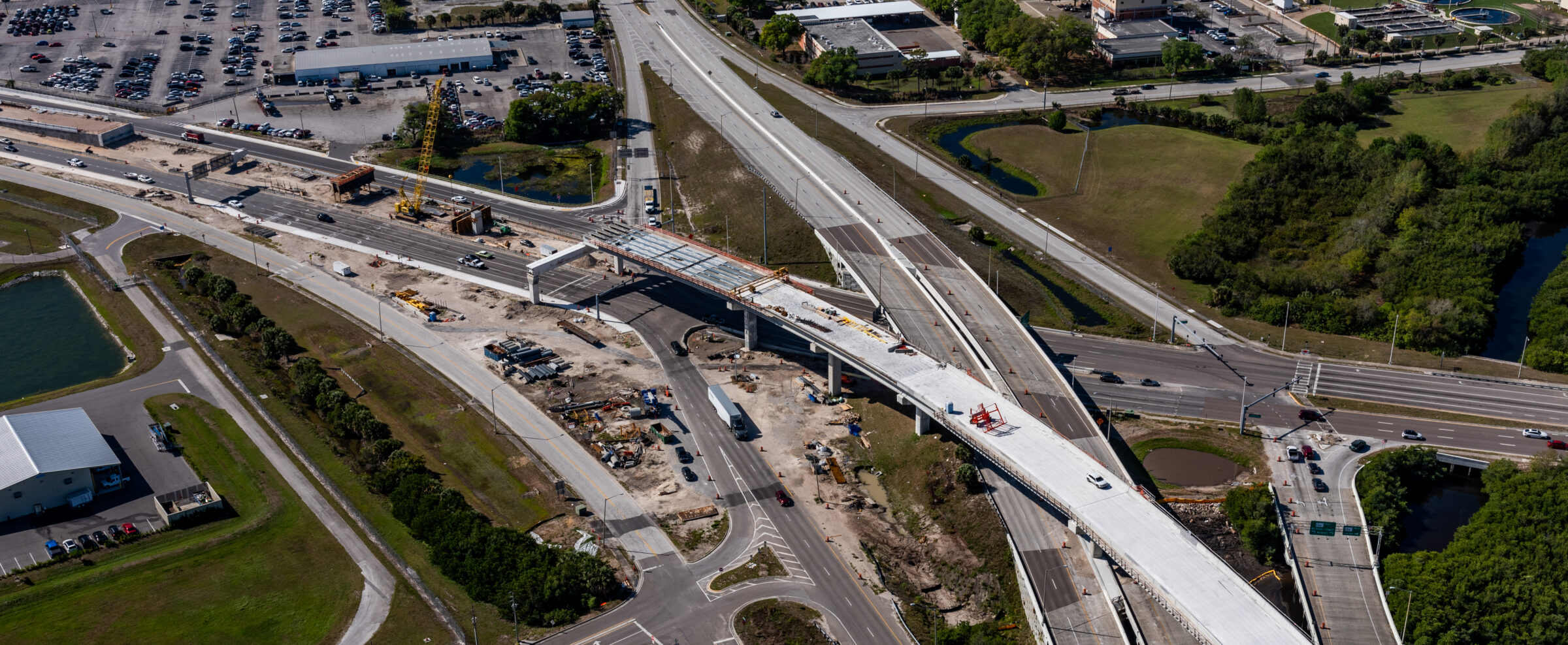 Aerial view of highway construction at Pinellas Gateway Expressway, showing multiple overpasses and surrounding areas