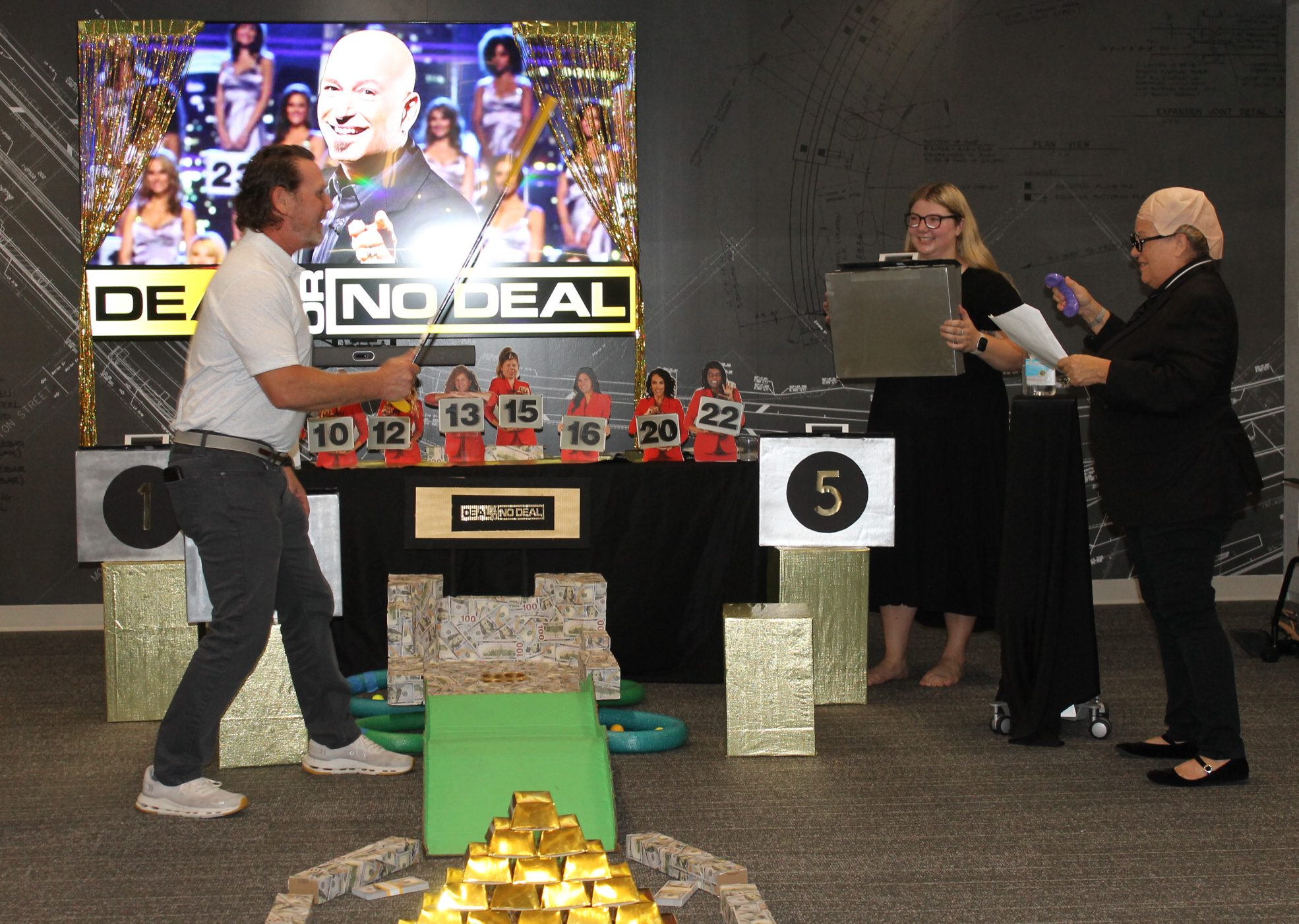 "Putt-Putt-4.jpg" person swings golf club in "Deal or No Deal" game setup