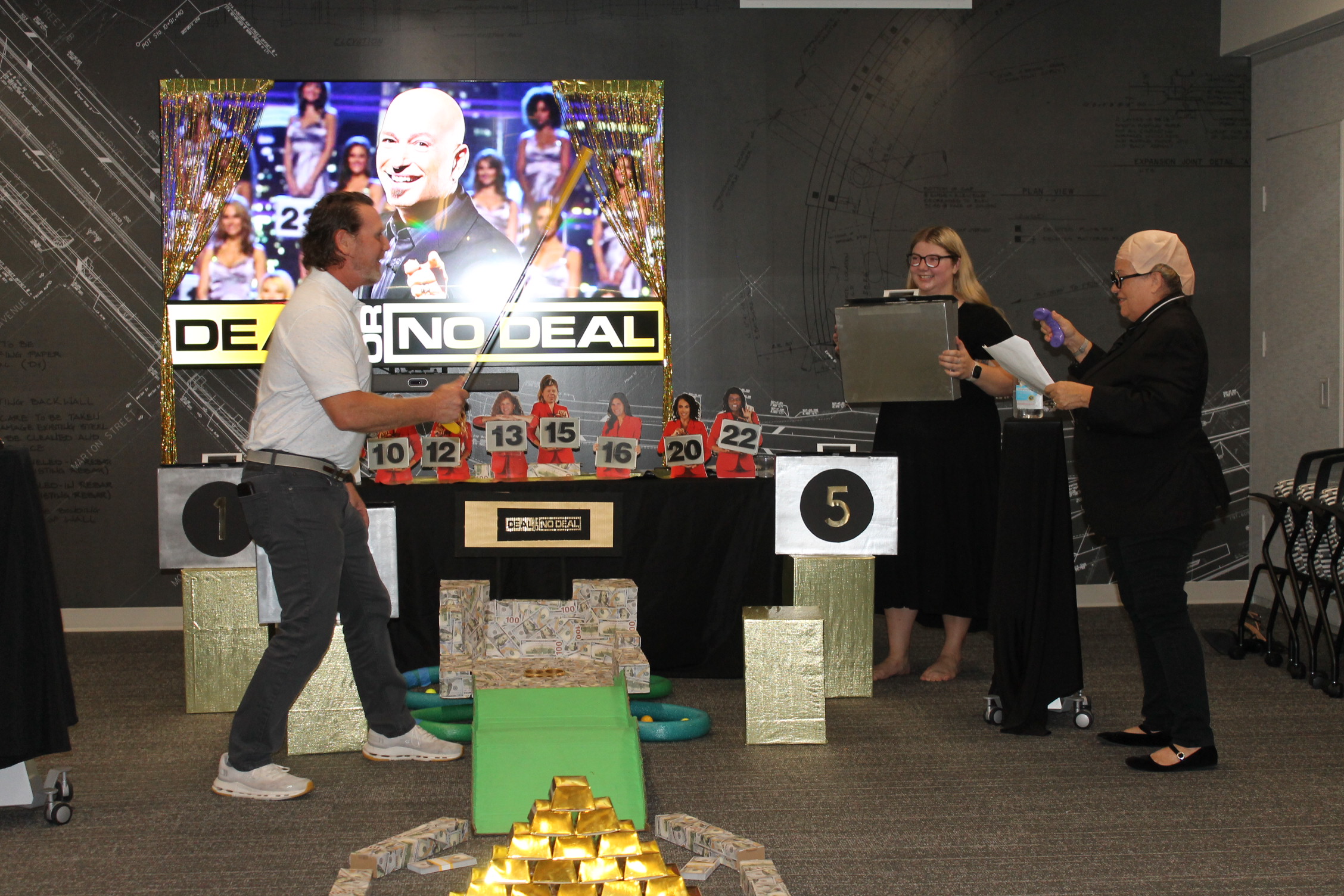 "Putt-Putt-4.jpg" person swings golf club in "Deal or No Deal" game setup