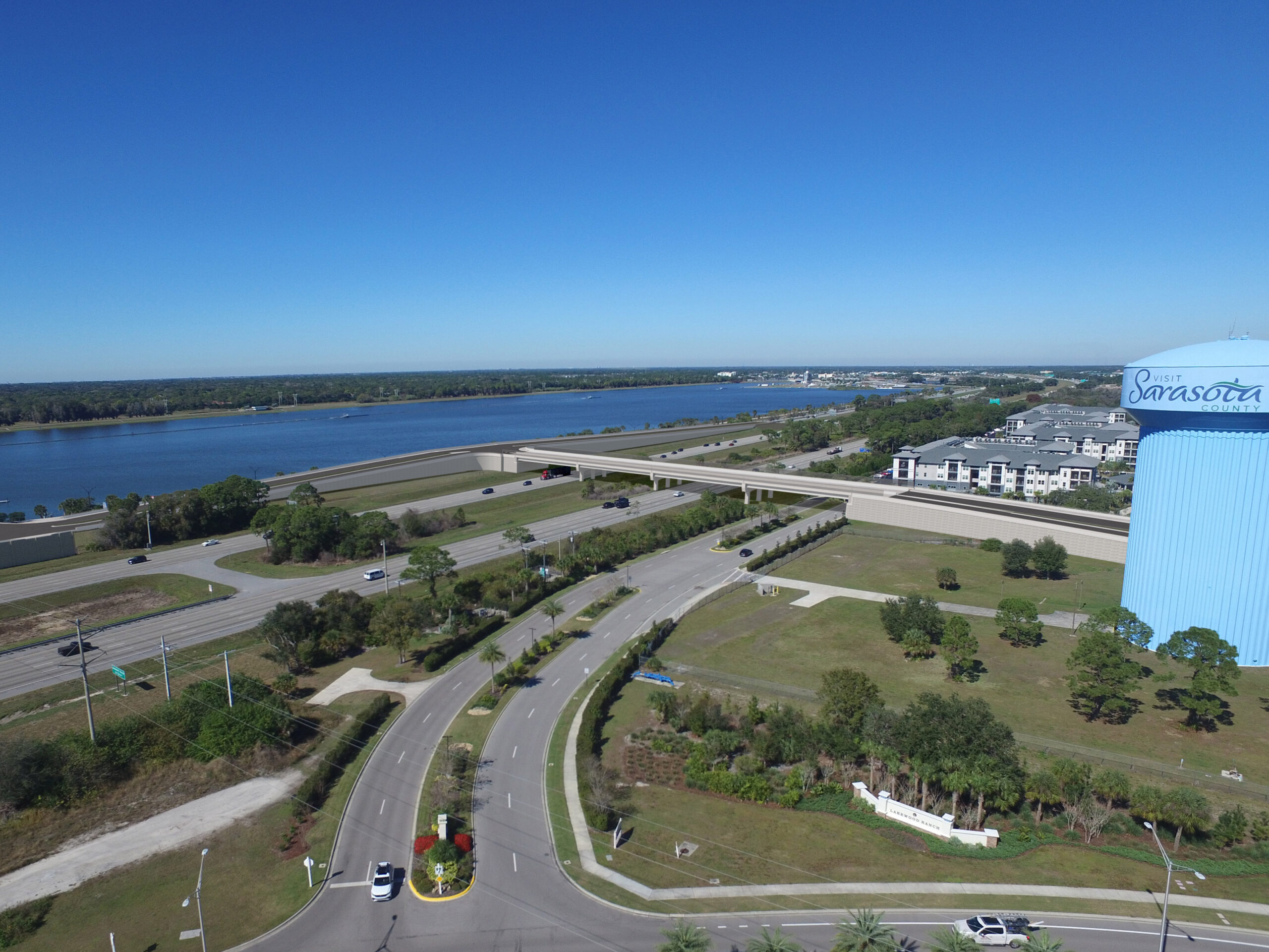 Aerial view of Sarasota County, showing roads, a river, buildings, and a large blue water tower with "Visit Sarasota County" text