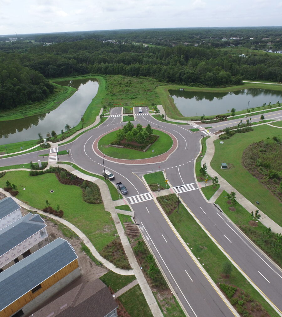 Aerial view of a roundabout with surrounded by greenery and ponds