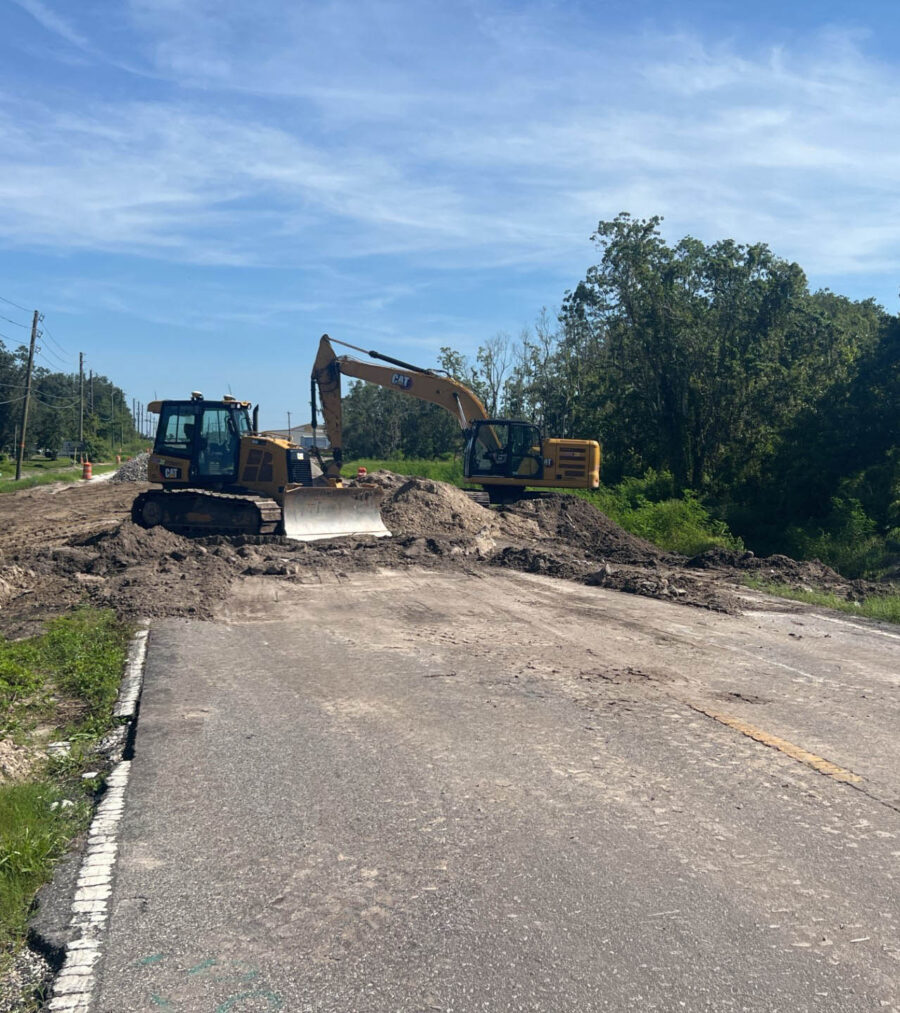 Construction site with excavators moving dirt on a sunny day