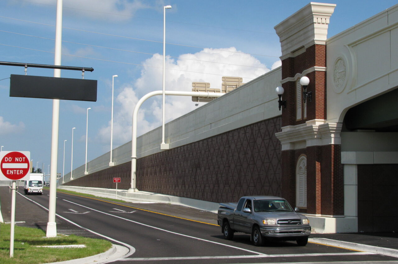 Truck approaching "Do Not Enter" sign near large overpass