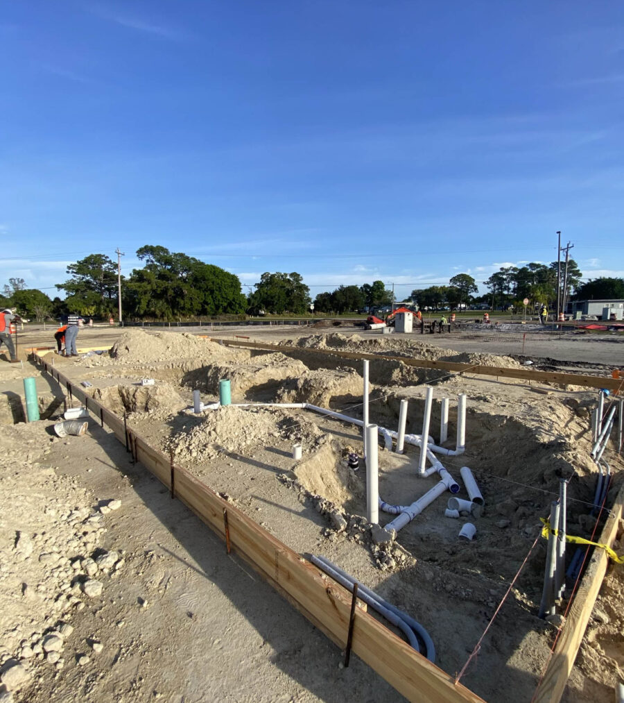 Construction site with visible plumbing pipes and wooden framework