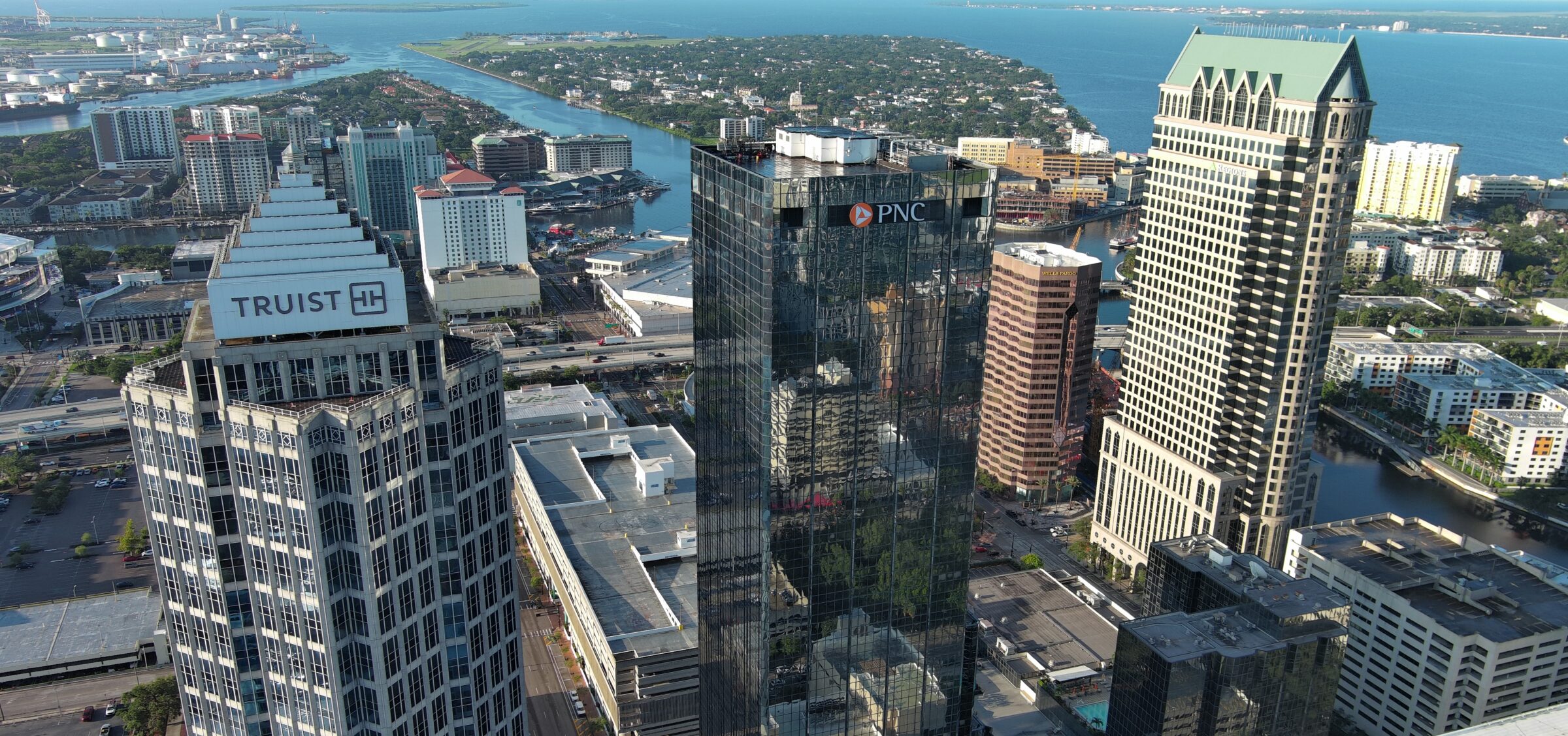 Aerial view of cityscape featuring Truist and PNC buildings near waterfront