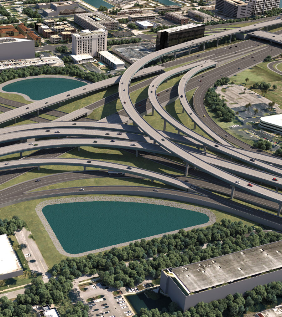 Aerial view of multi-level highway interchange with surrounding urban landscape and green spaces