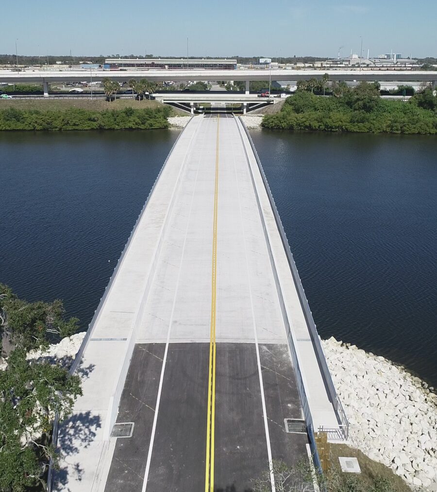 Wide concrete bridge over water with yellow center line