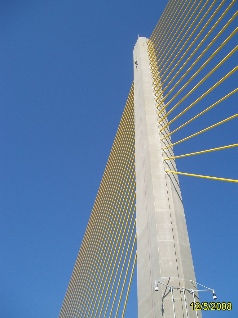 Looking up at a cable-stayed bridge tower with yellow cables against a clear blue sky, dated 12/5/2008