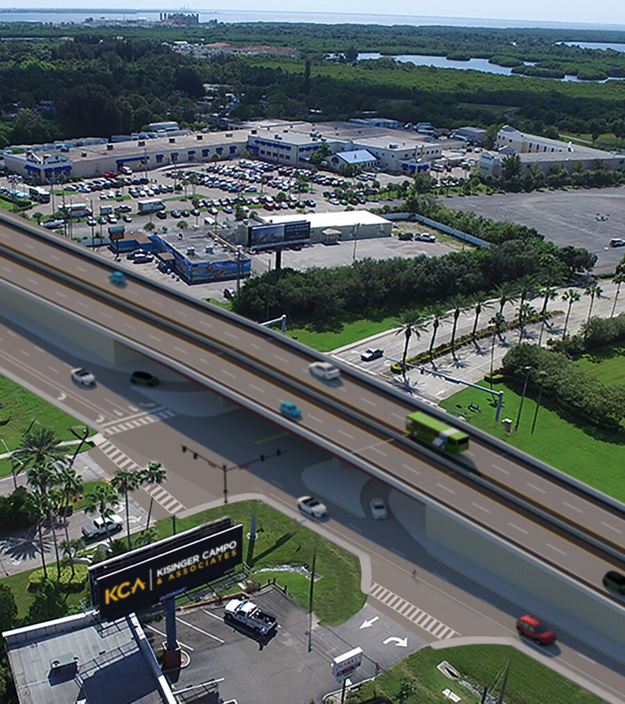 Elevated highway overpass with vehicles; commercial area below; Kisenger Campo & Associates billboard visible
