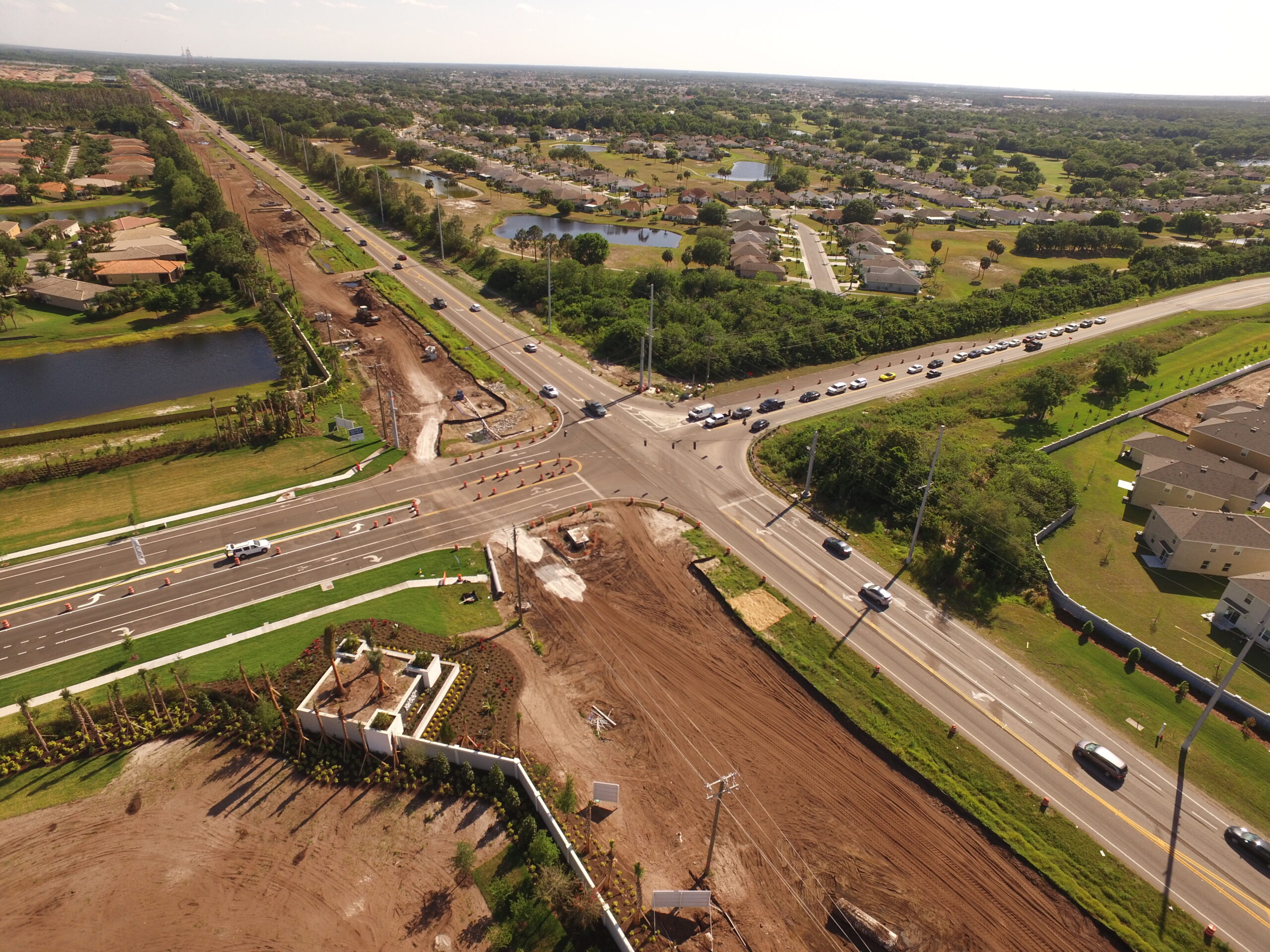 Aerial view of busy intersection with ongoing construction and surrounding suburban area