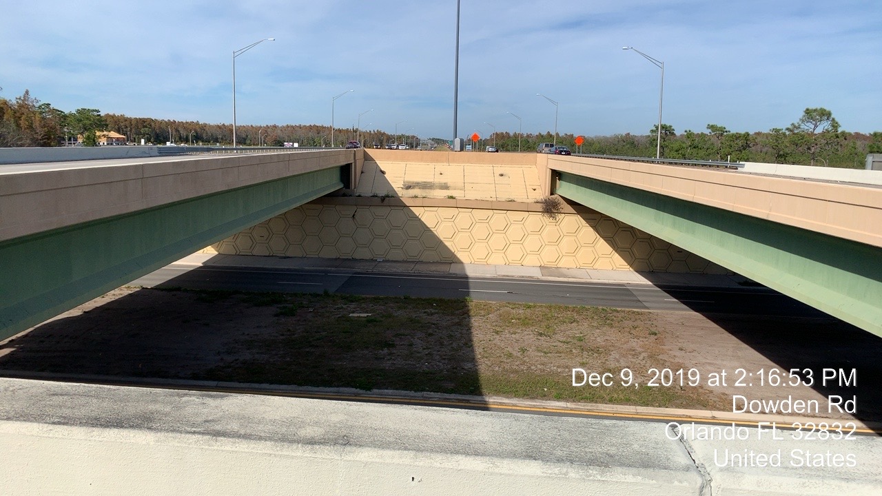 View of overpass with textured walls; date/time stamp: Dec 9, 2019, 2:16:53 PM, Dowden Rd, Orlando FL 32832