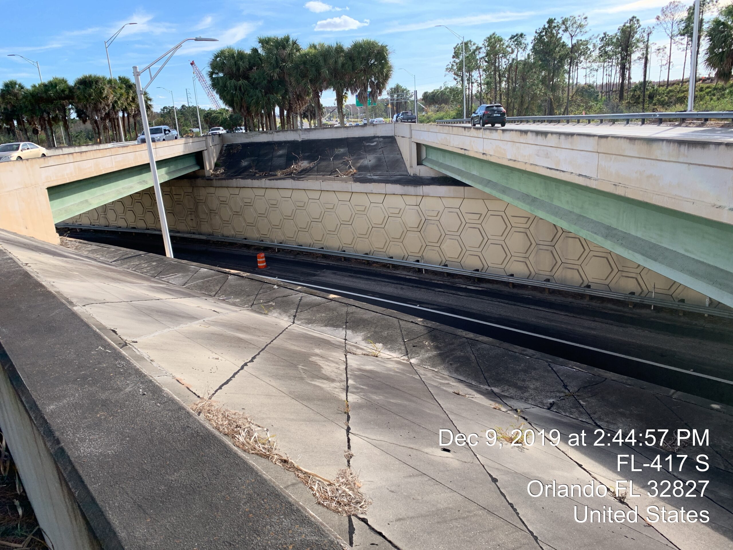 Highway overpass with palm trees and traffic on FL-417 S, Orlando. Date and time text overlay: Dec 9, 2019, 2:44:57 PM