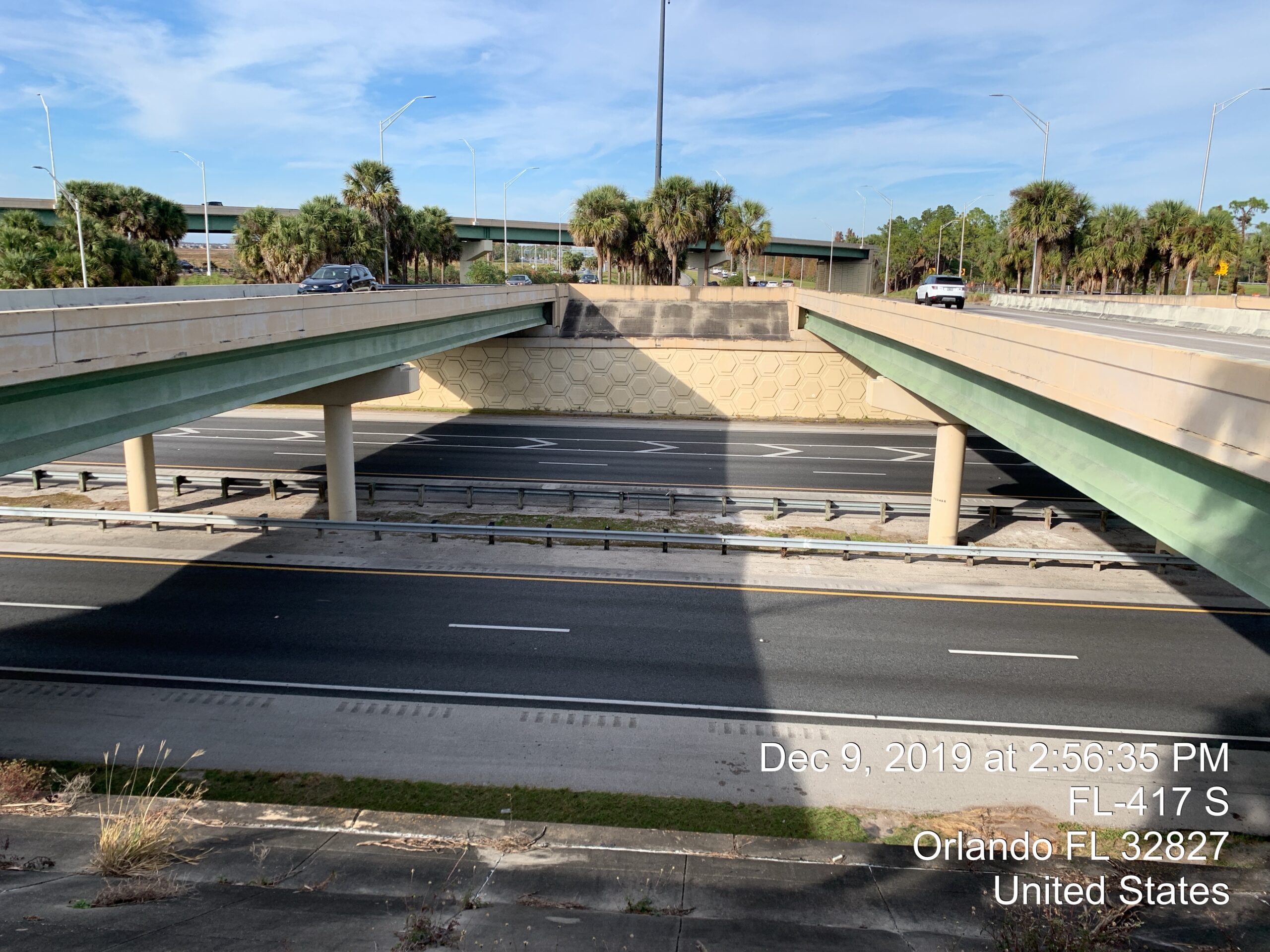 Highway overpass with cars passing, date and location overlay: "Dec 9, 2019, FL-417 S, Orlando FL 32827, United States"