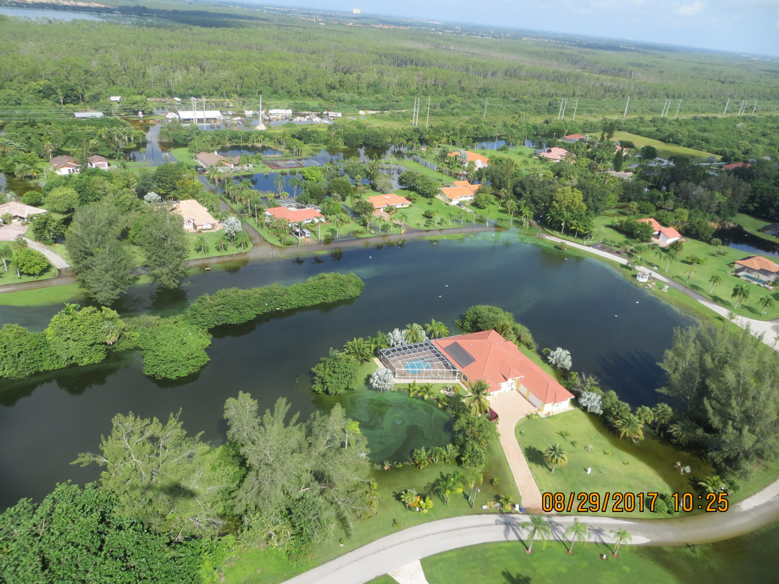 Aerial view of a lush, residential area with lakes and greenery