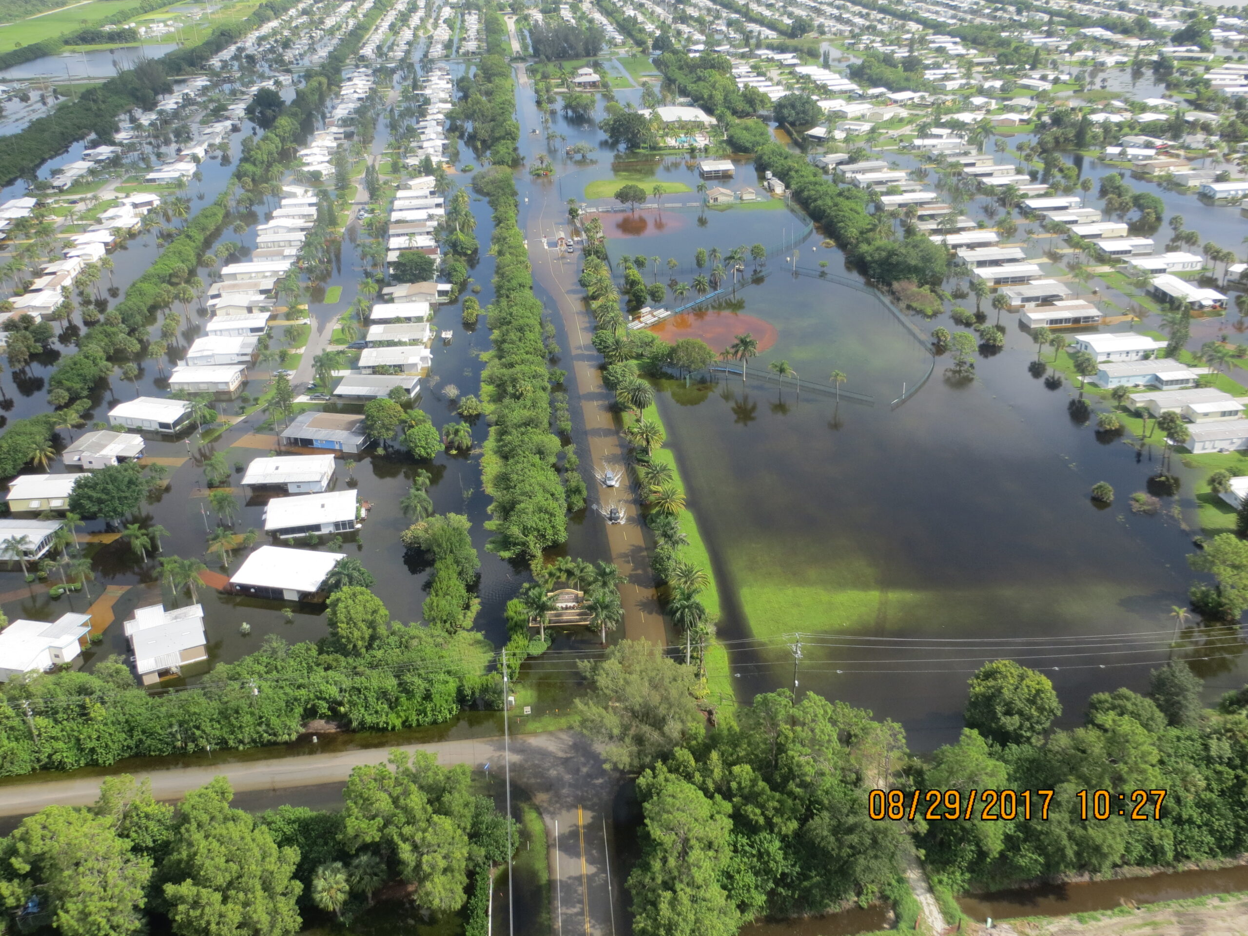 Aerial view of a flooded residential area with visible waterlogged streets and homes. Date: 08/29/2017 10:27