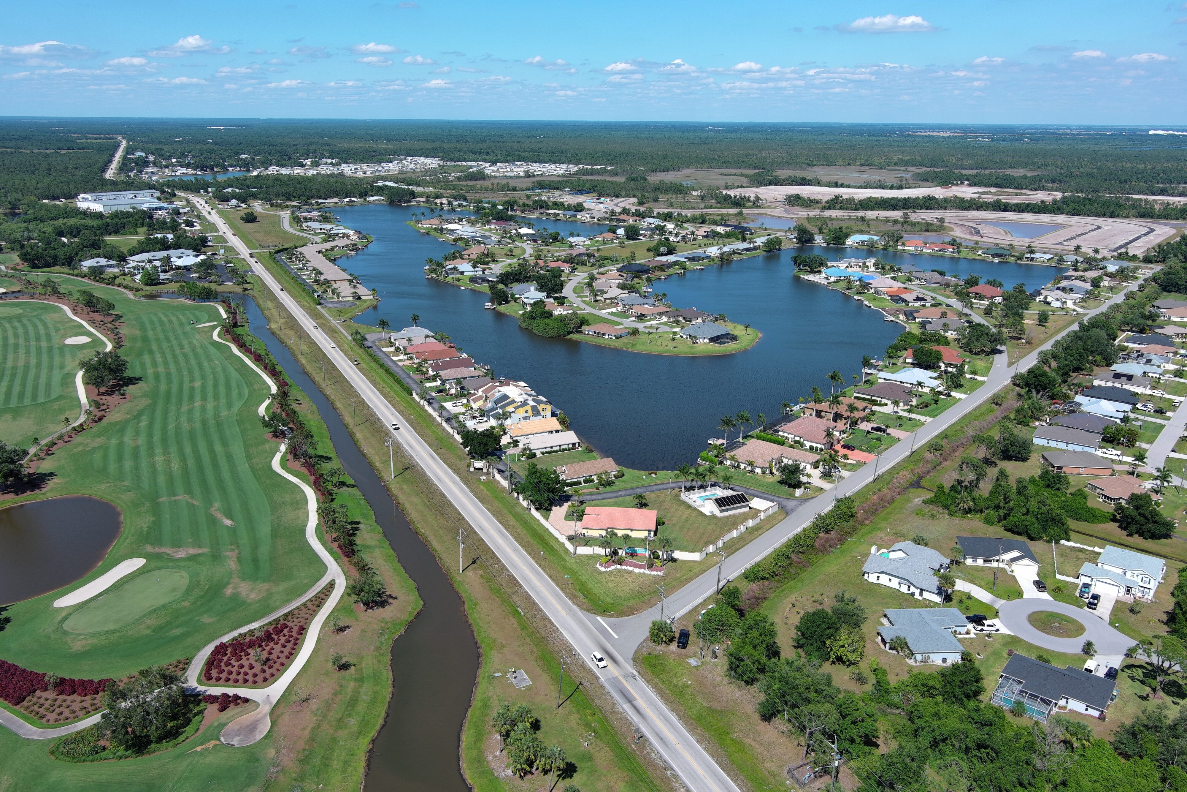 Aerial view of Kings Highway with Courtly Manor Drive area, featuring lakes, residential homes, roads, and a golf course