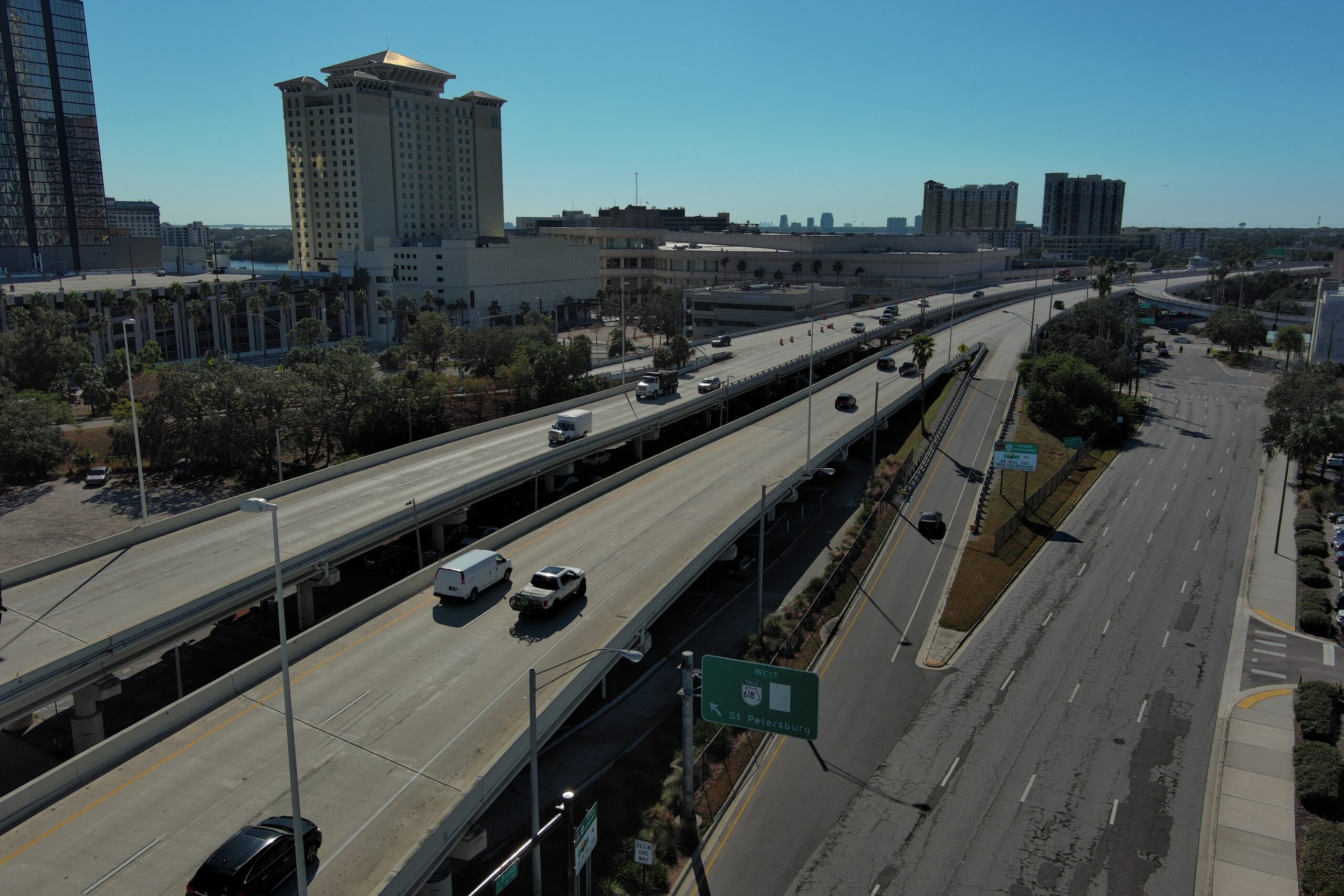 Elevated highway with traffic, large building, and sign for St. Petersburg