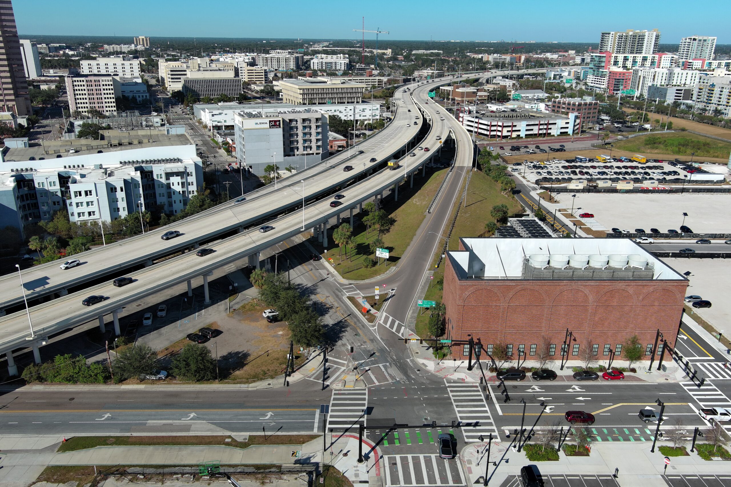 Aerial view of a highway interchange in an urban area with several cars