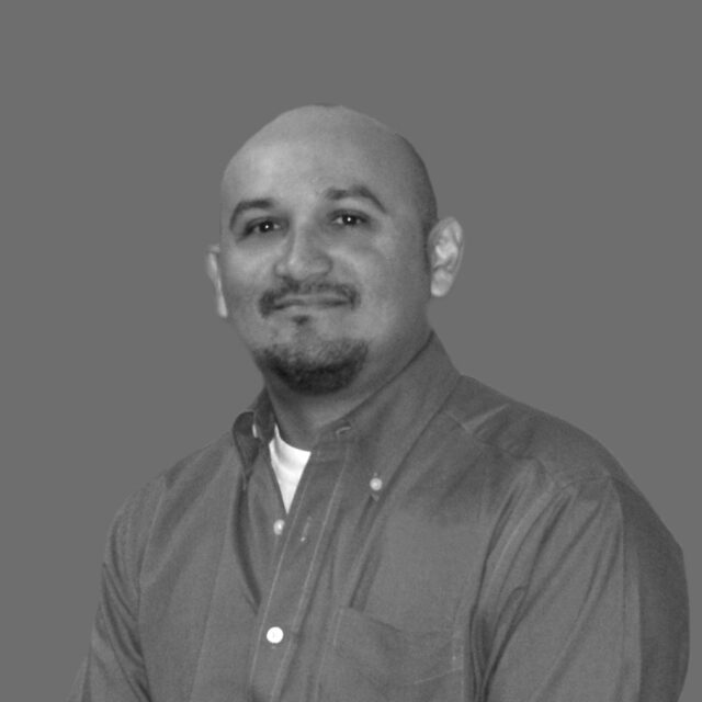 Rodriguez Antonio smiling confidently in a grayscale portrait