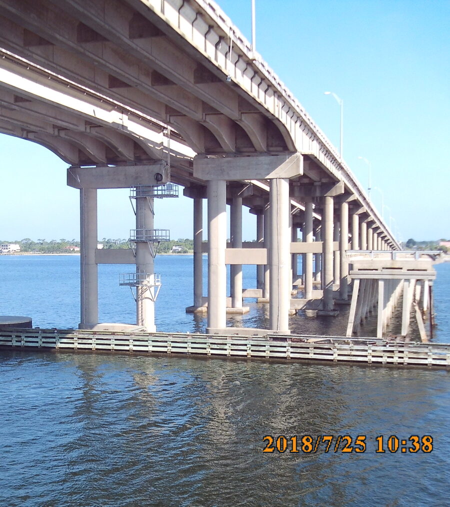 Long concrete bridge extending over blue water, dated 2018/7/25 10:38