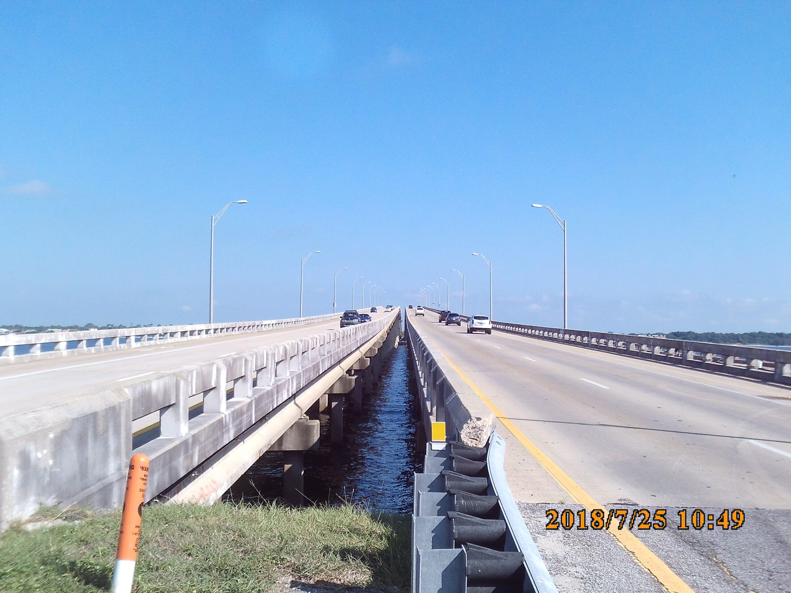 Two-lane bridge with cars, blue sky, and timestamp "2018/7/25 10:49" visible
