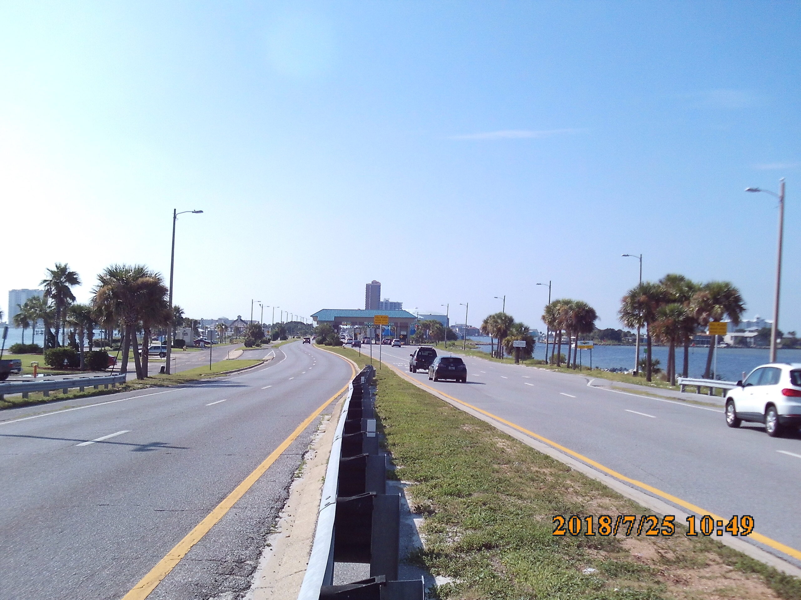 Sunny roadway lined with palm trees, 2018/7/25 10:49 timestamp