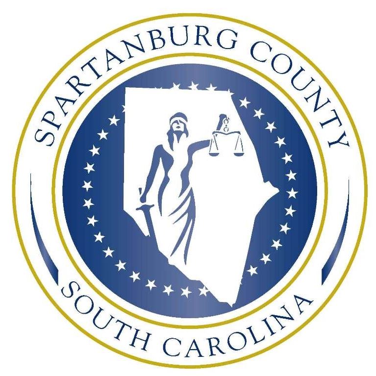 Spartanburg County South Carolina logo, featuring Lady Justice silhouette surrounded by stars
