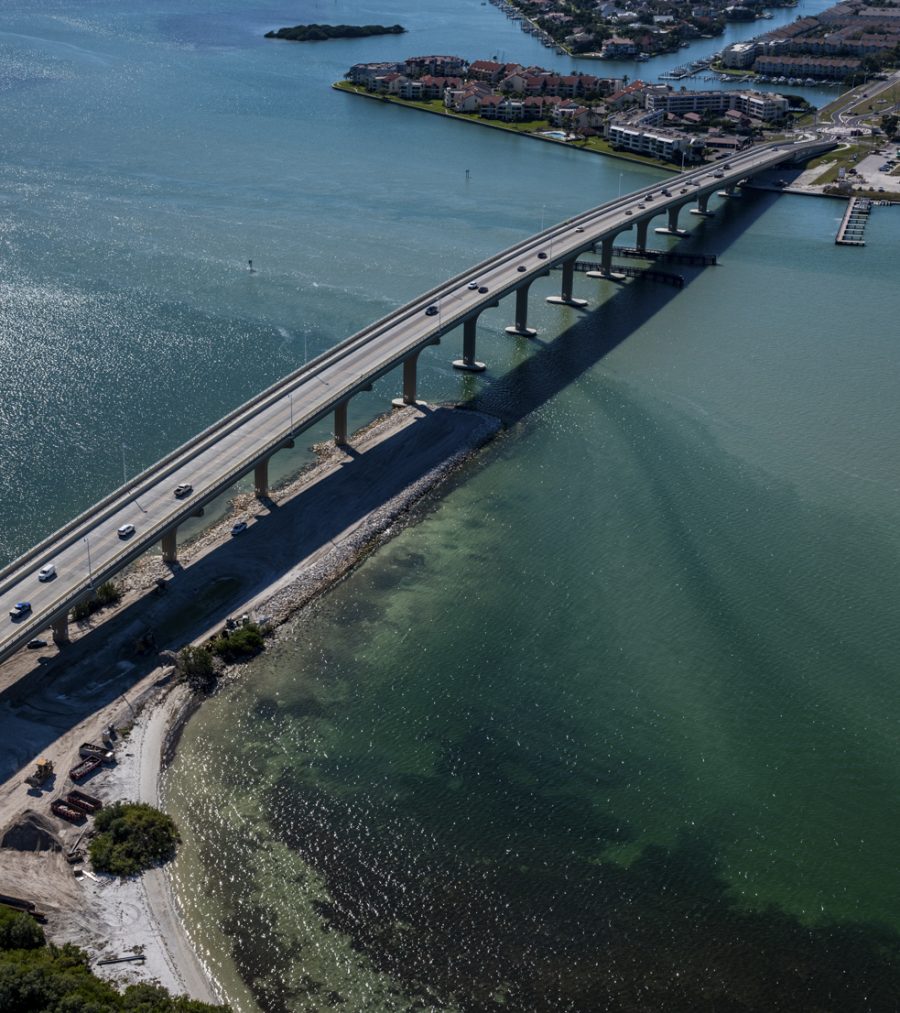 Aerial view of Pinellas Bayway bridge over shimmering water, connecting an island to the mainland