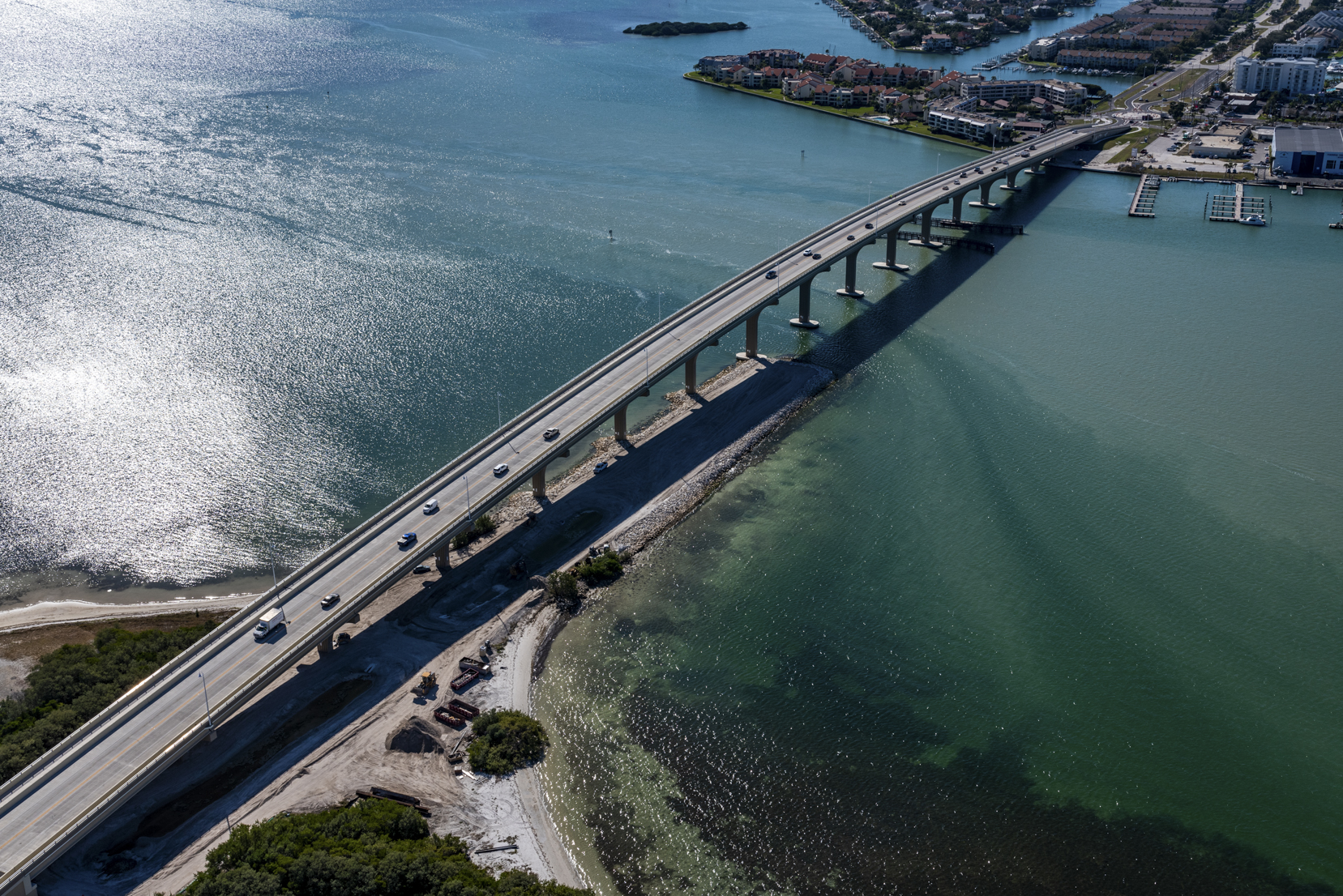 Aerial view of Pinellas Bayway bridge over shimmering water, connecting an island to the mainland