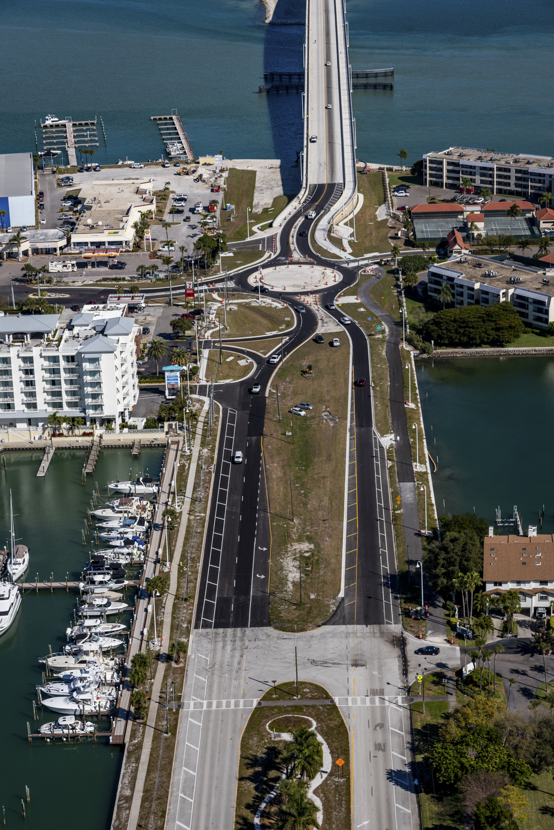 Aerial view of Pinellas Bayway bridge, featuring surrounding buildings, marina, and roadways