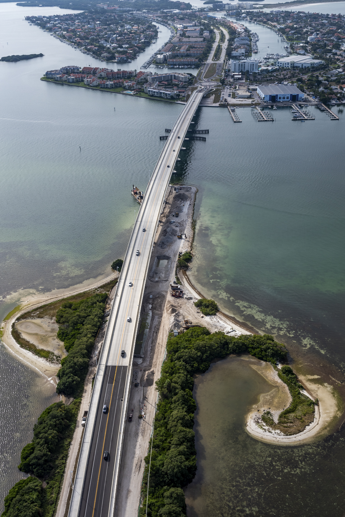 Aerial view of Pinellas Bayway with cars driving, surrounded by water and greenery