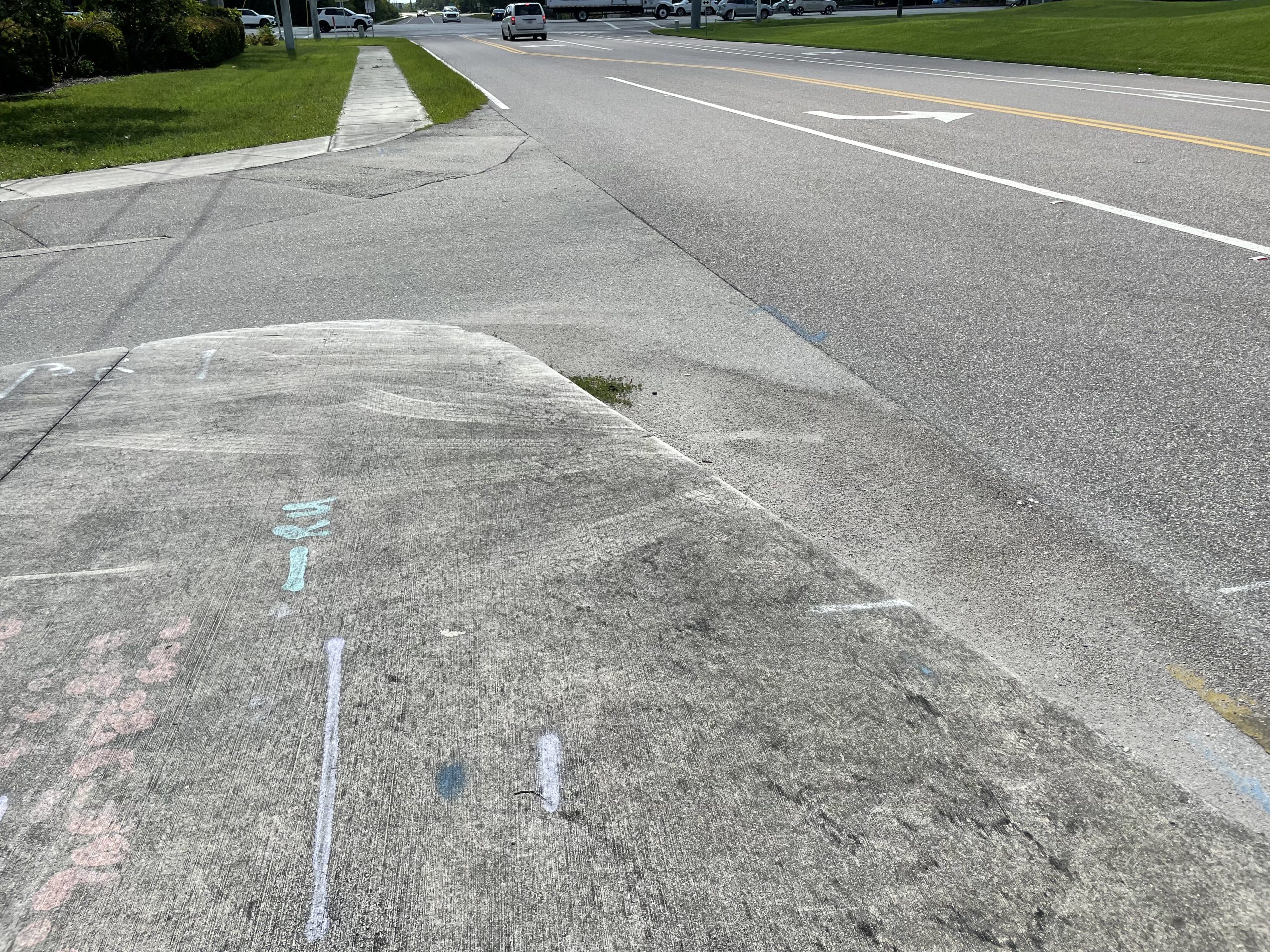 Sidewalk abruptly ends at road without a crosswalk or ramp